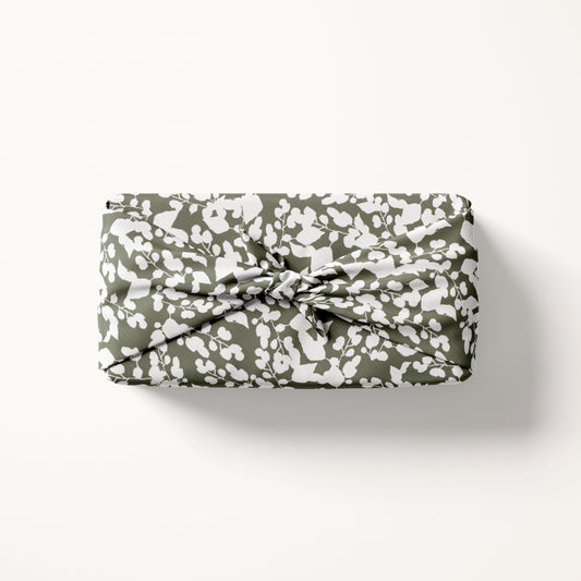 fabric gift wrap in white and green on cream background