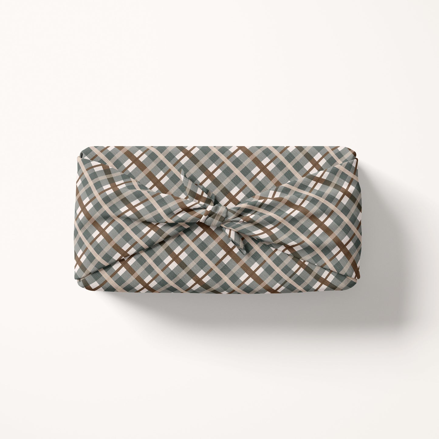 Gift wrap fabric with a plaid pattern on a white background