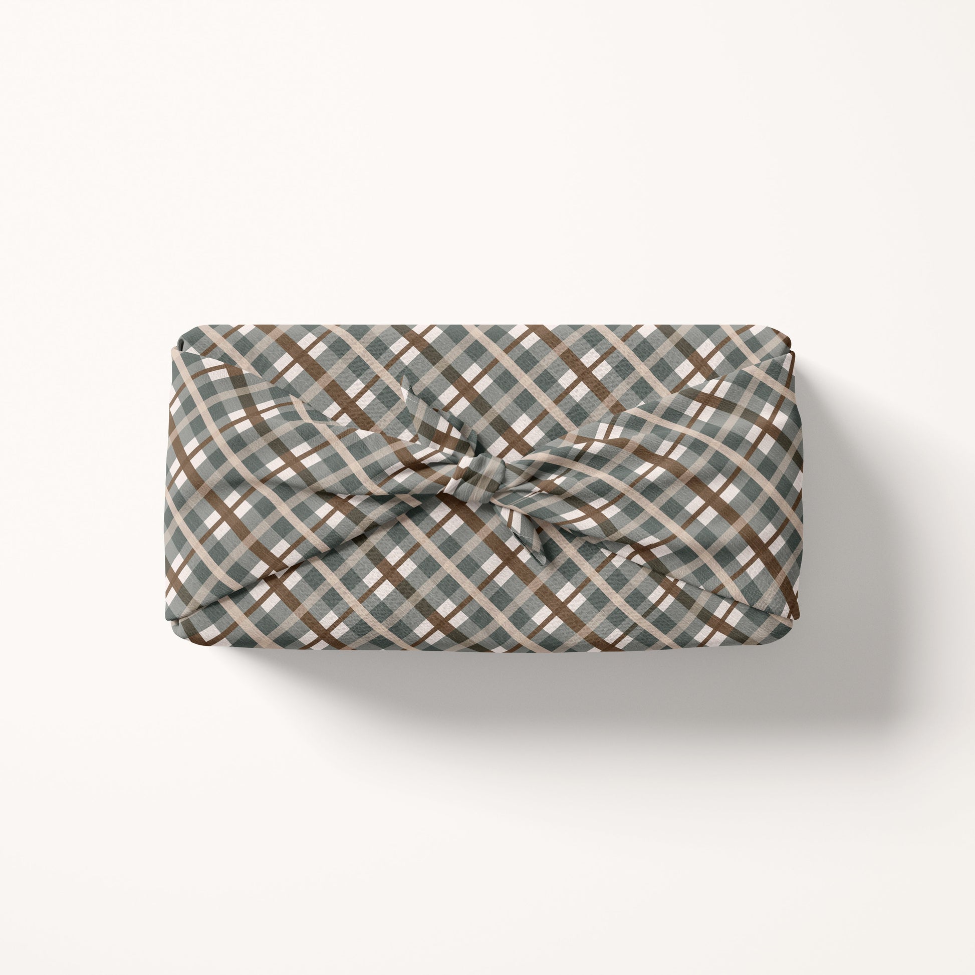 Gift wrap fabric with a plaid pattern on a white background