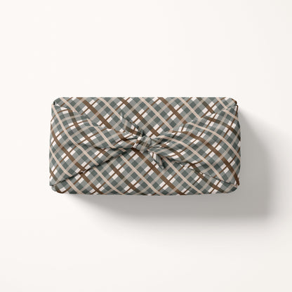 Gift wrap fabric with a plaid pattern on a white background