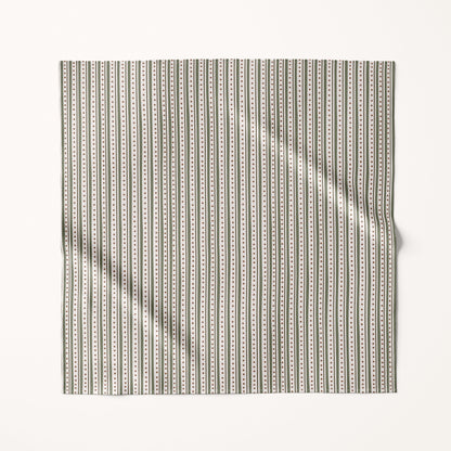 Christmas green stripes fabric square with a subtle pattern on a cream background