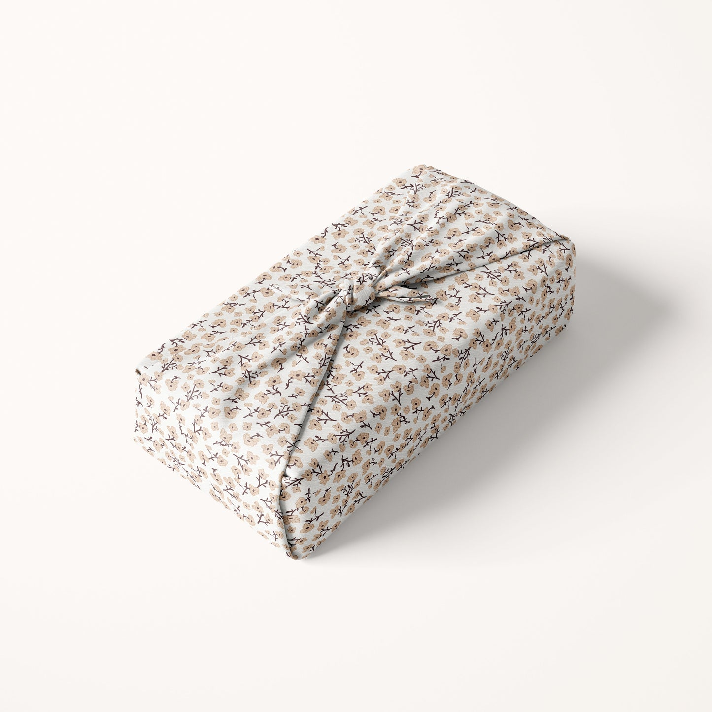 Rectangular gift box wrapped in floral patterned fabric on a white background