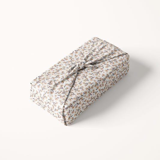 Rectangular gift box wrapped in floral patterned fabric on a white background