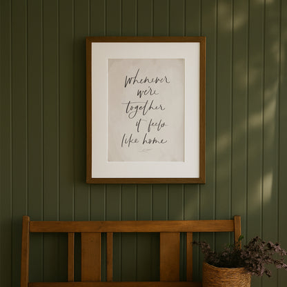 Framed artwork with text on a green wall above a wooden bench. hand lettered family quote art print saying whenever were together