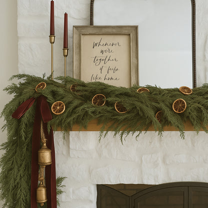 Decorative Christmas mantel with greenery, candles, and a framed quote on a white wall. Framed hand lettered family quote art print saying whenever were together