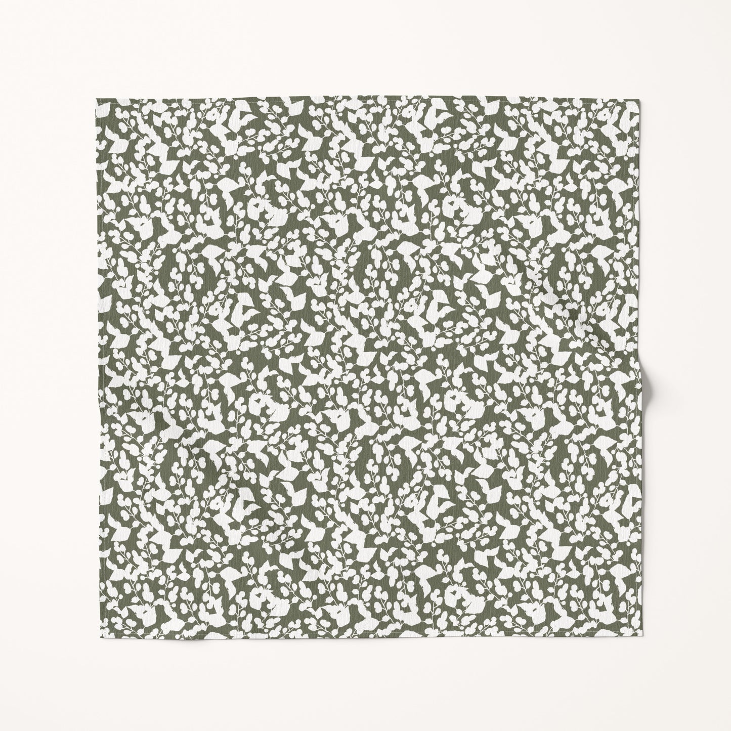 Textured green and white Christmas fabric swatch on a white background