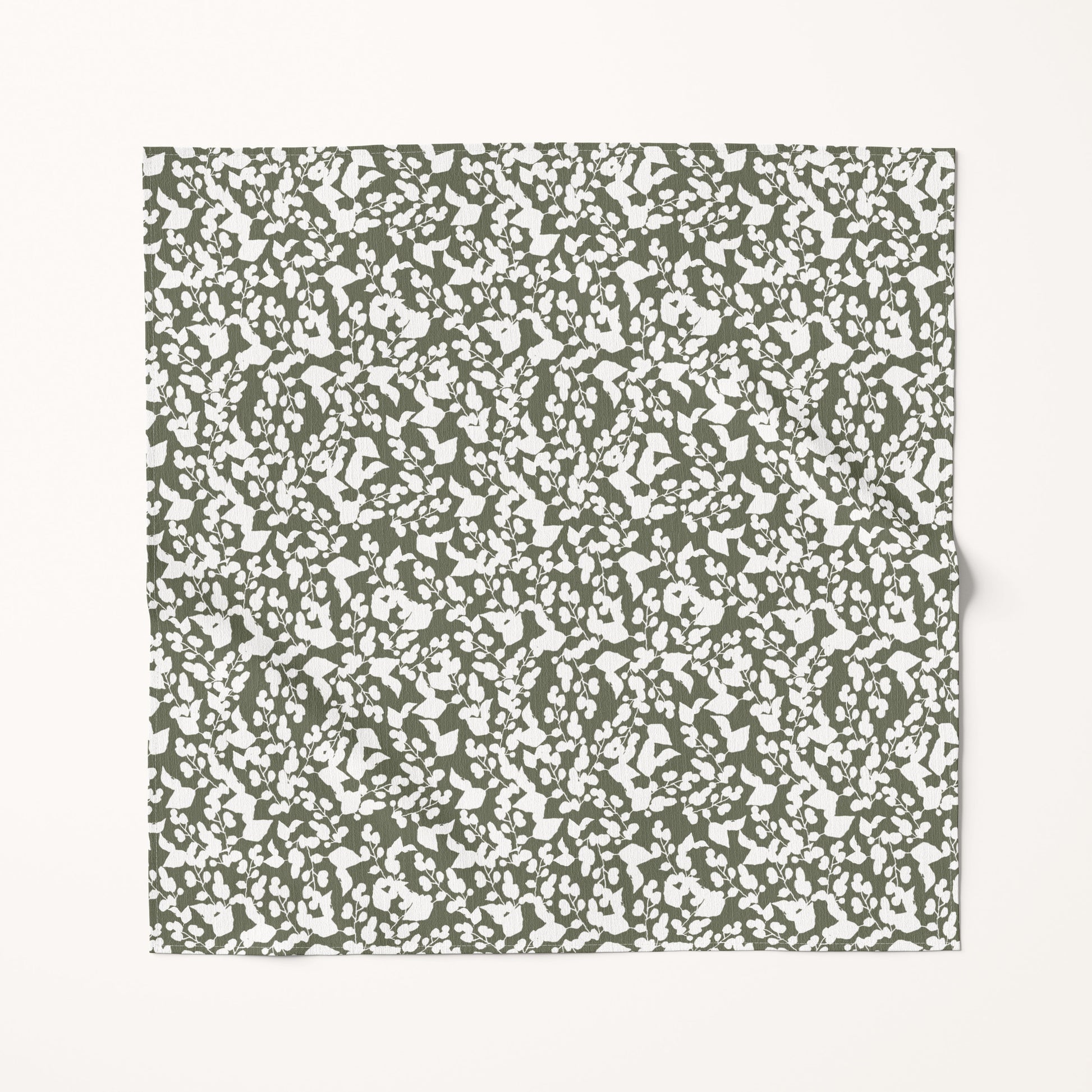 Textured green and white Christmas fabric swatch on a white background