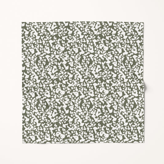 Textured green and white Christmas fabric swatch on a white background