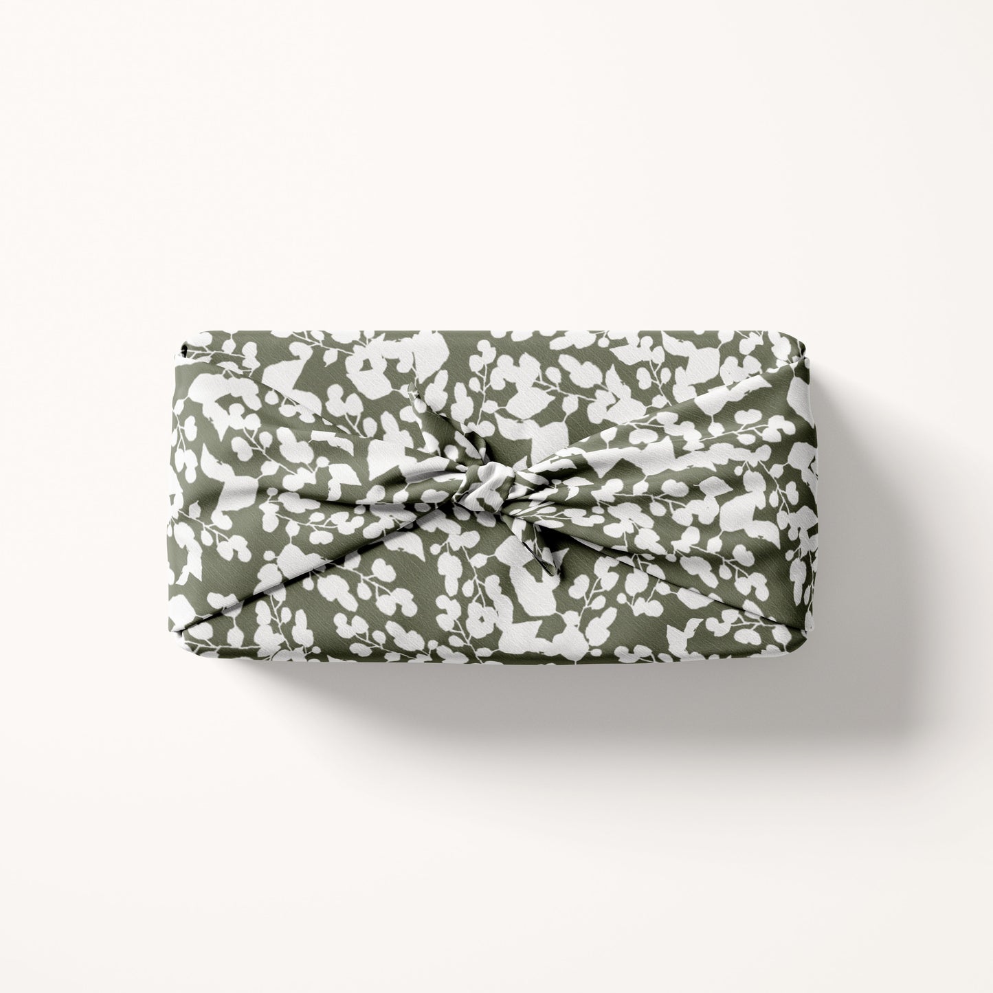 fabric gift wrap in white and green on cream background