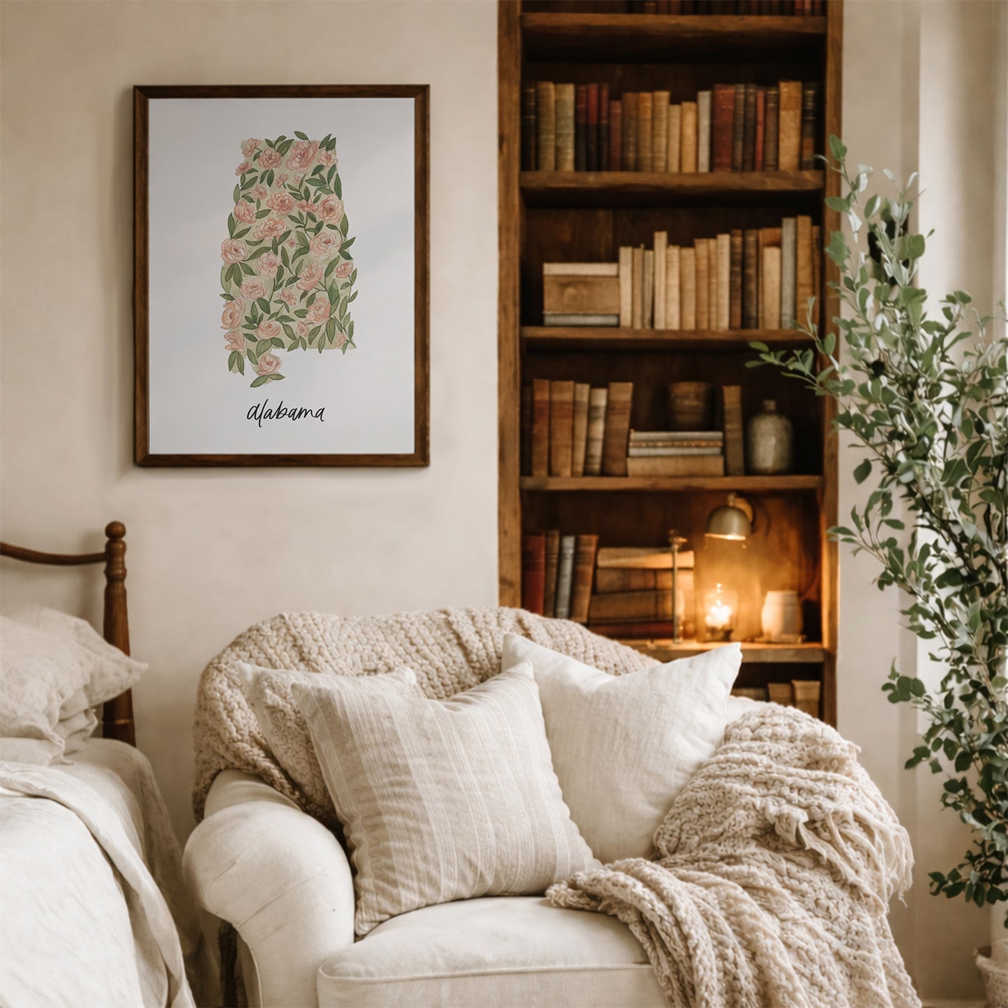 Alabama state flower Camellia watercolor art print on wall in a cozy living room with a bookshelf, armchair, and decorative elements.
