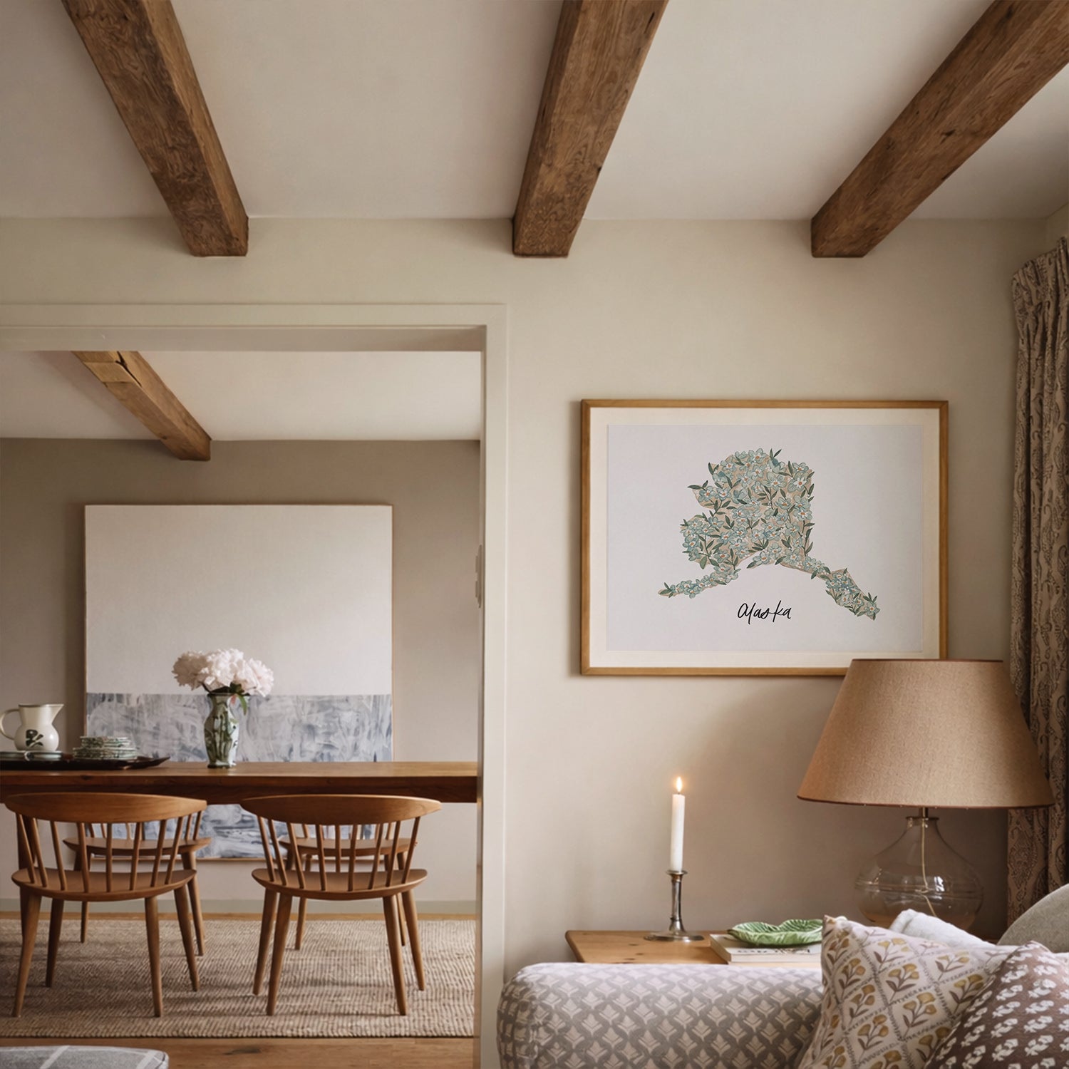 Framed Alaska state flower Forget-Me-Not watercolor art print on wall in living room with wooden beams, and a lamp.