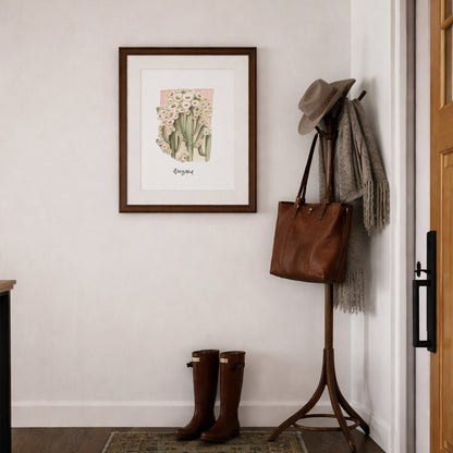 Entryway with a coat rack, boots, and framed Arizona state flower Saguaro Cactus Blossom watercolor art print framed on a wall.