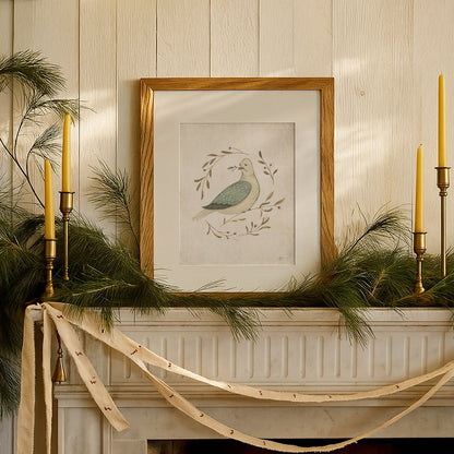 Festive fireplace mantel with candles, greenery, and a framed artwork of a dove. watercolor dove peace on earth christmas art print