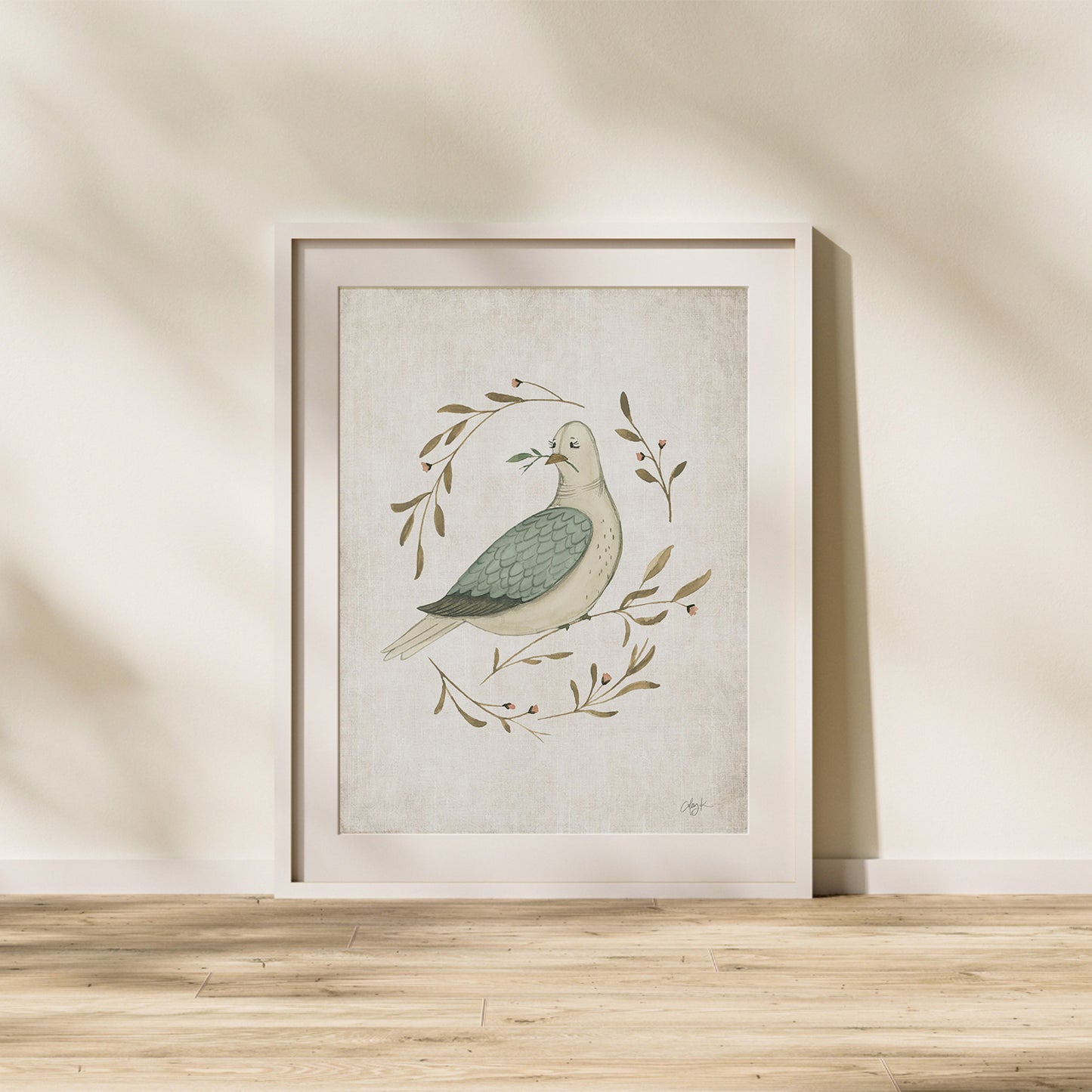 Framed artwork of a dove with leaves on a beige wall. watercolor dove peace on earth christmas art print